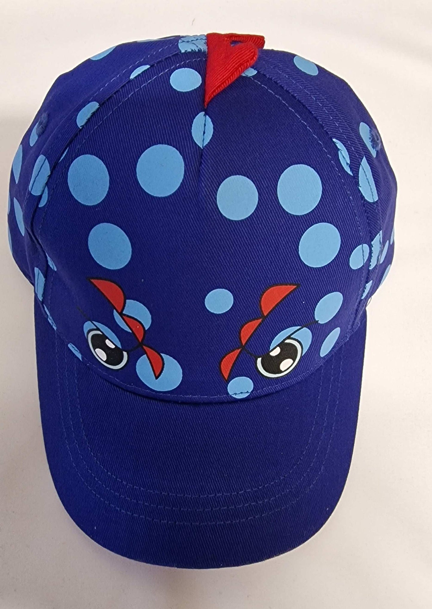 Blue cap with cartoon face design on a white background