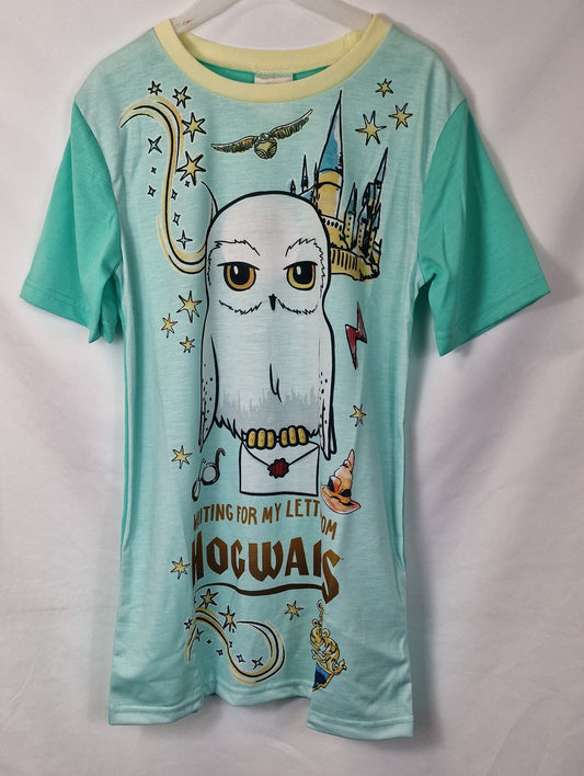 Teal t-shirt with owl graphic and 'Hogwarts' text on a white background