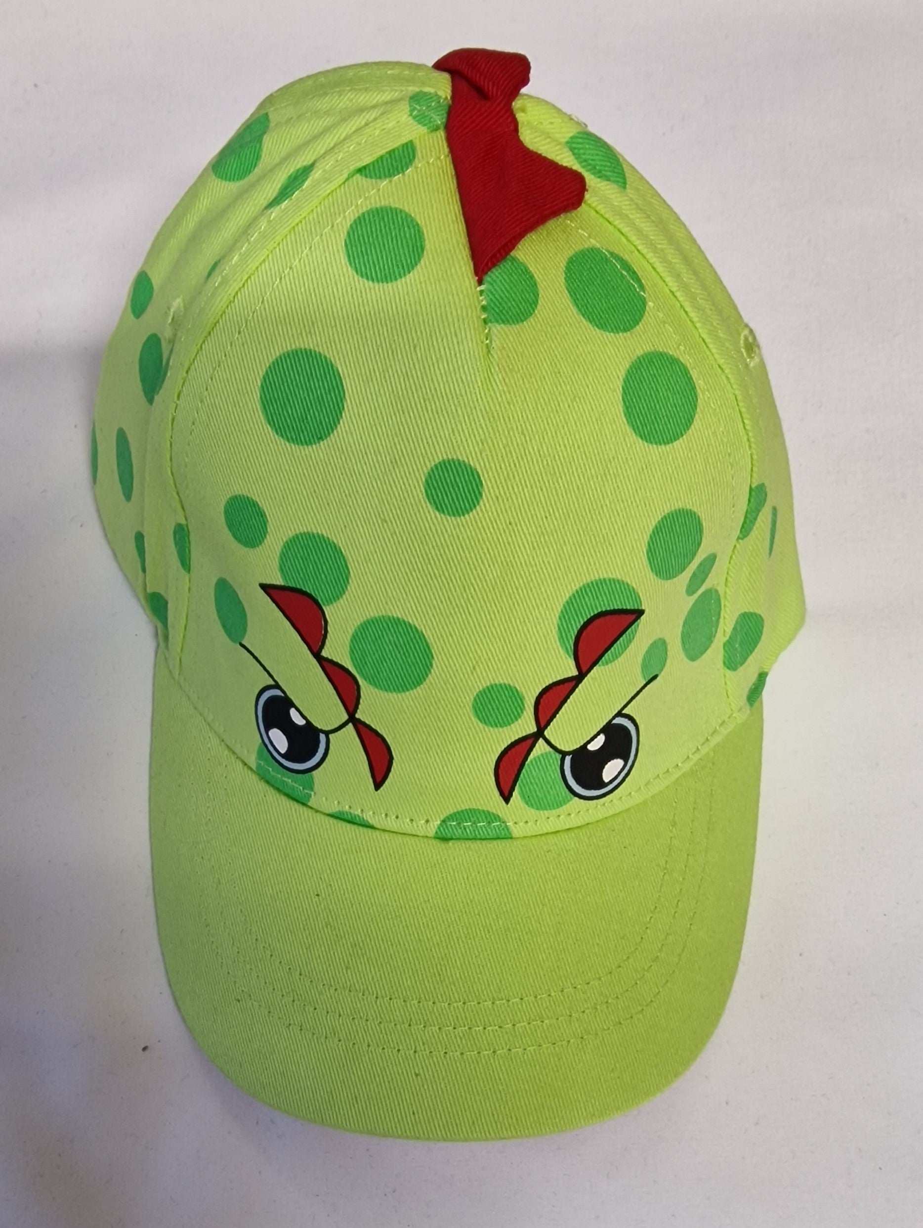 Green polka dot cap with cartoon face design on a white background