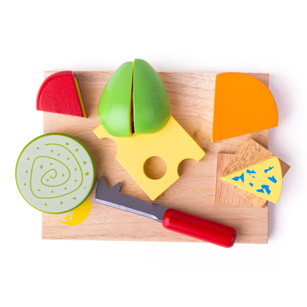 Colorful toy cheese set with a wooden board and knife on a white background