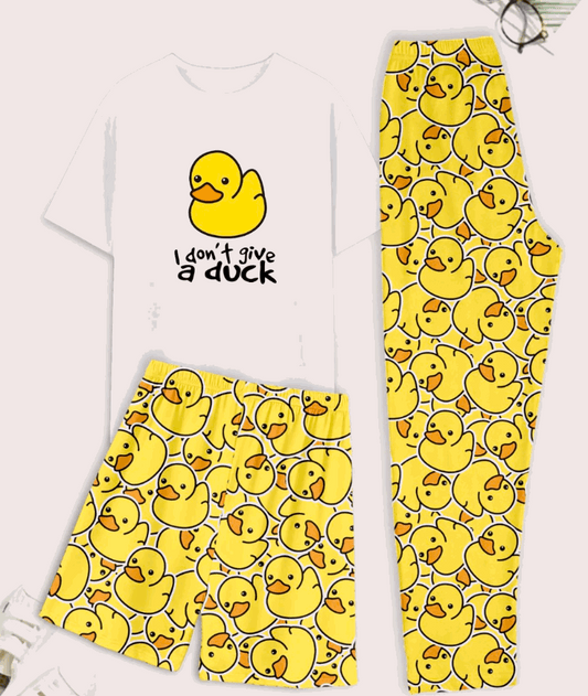 White t-shirt with yellow duck graphic and text, paired with yellow duck-patterned pants on a light pink background.