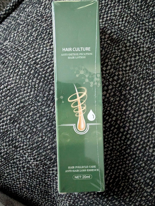 Green hair care product box on a textured black surface