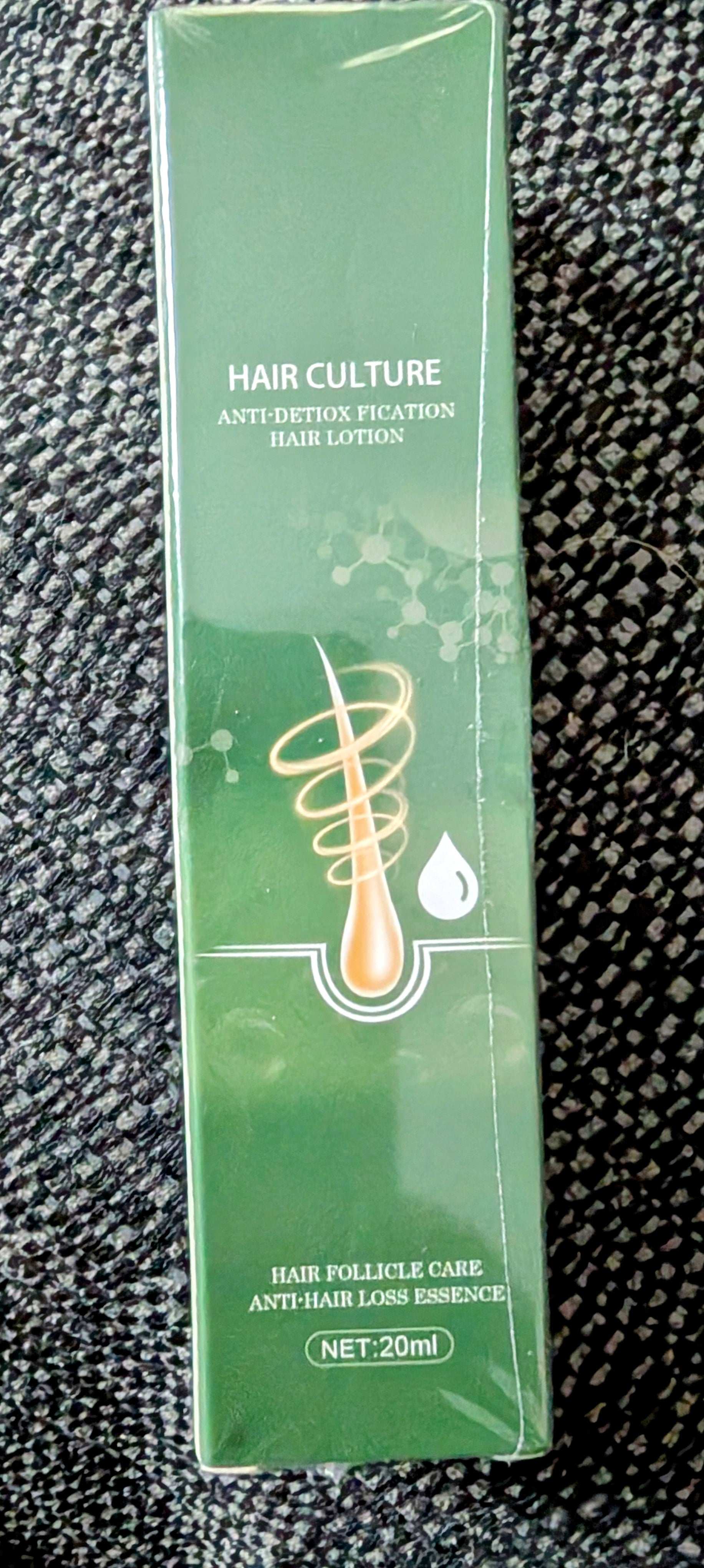 Hair care product packaging on a textured black background