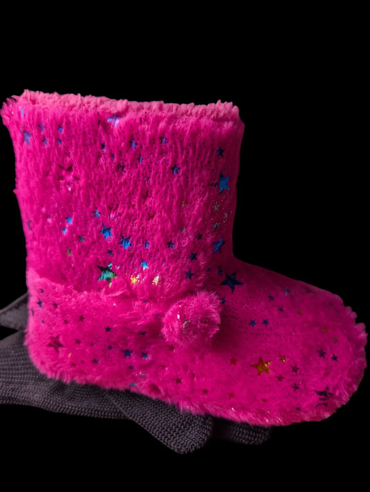 Pink fuzzy boot with star patterns on a black background